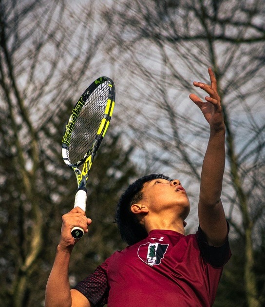 Kevin Song playing tennis outdoors